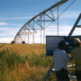 two men working on center pivot irrigation system