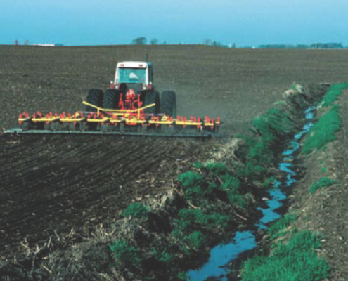tractor next to a small stream
