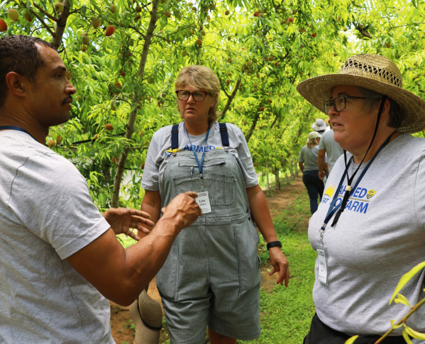 Justin Duncan speaks with two farmers at a training