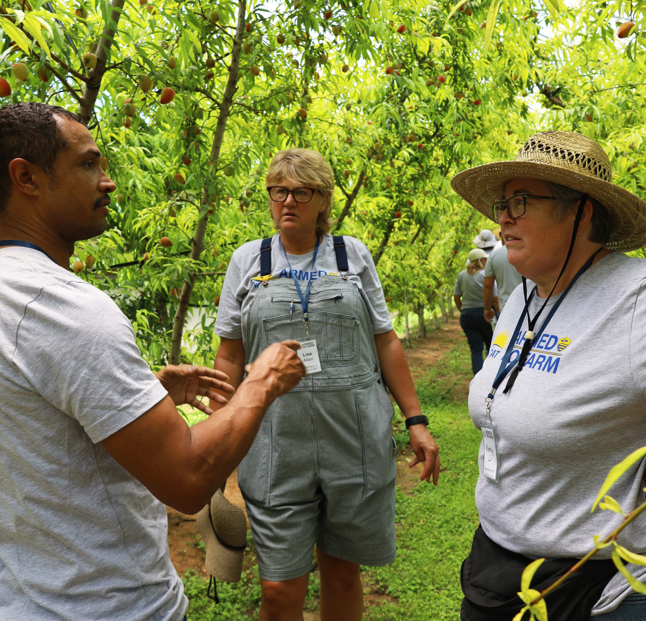 Justin Duncan speaks with two farmers at a training