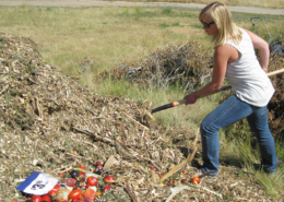 woman turning compost