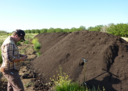 Farmer Chris Hay, Say Hay Farms, inspecting compost prior to application by spreader.