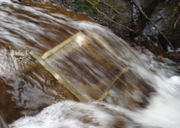 A micro-hydro intake and penstock temporarily divert a portion of the water flow and carry it to the location of the turbine.