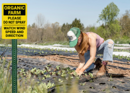 girl planting crops near no-spary sign