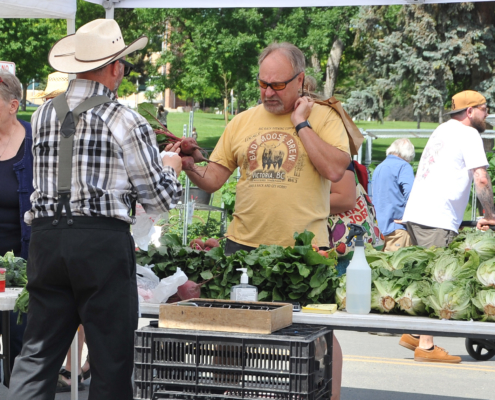 A man purchases fresh produce at the Helena, Montana farmers market.