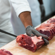 A person cuts sections of beef