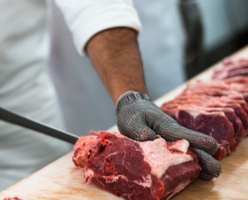 A person cuts sections of beef