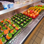 vegetables and fruits in school lunch distribution display