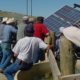 Ranchers around a solar energy system