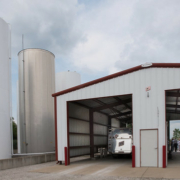 storage silos and a large metal building with open overhead doors
