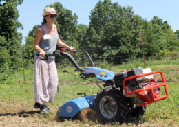 woman using two-wheel tractor with tiller