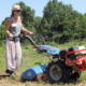 woman using two-wheel tractor with tiller