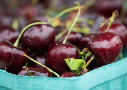 cherries with stems in a cardboard carton