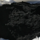 Pile of black biochar particles