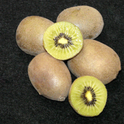 group of whole and cut kiwifruit against black background.
