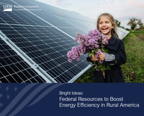 publication cover with photo of girl holding flowers standing in front of solar array.