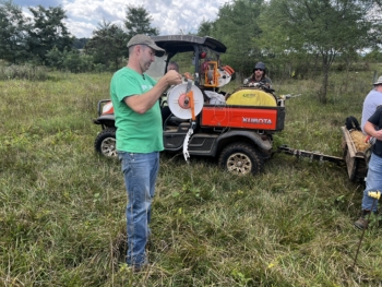 Photo of Buck Holsinger explains the use of polywire at the Armed to Farm training at HolsingerHomestead Farm, August 2024.