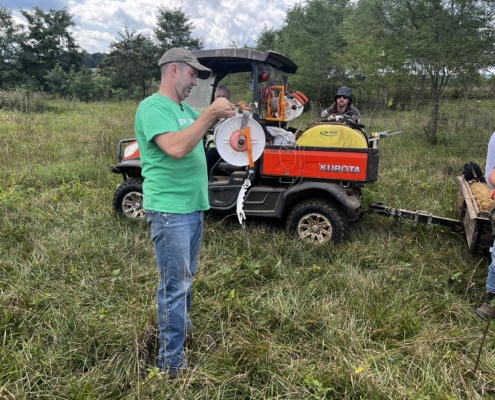 Photo of Buck Holsinger explains the use of polywire at the Armed to Farm training at Holsinger Homestead Farm, August 2024.