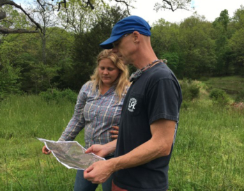 Photo of Emily Jost and Dr. Dirk Philipp looking over the farm map.