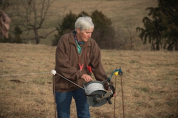 Photo of Tina Cone working with fencing