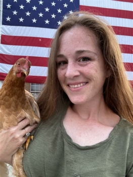 Photo of Summer Miracle holding a chicken