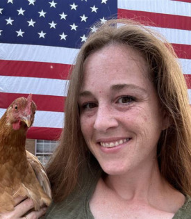 Photo of Summer Miracle holding a chicken