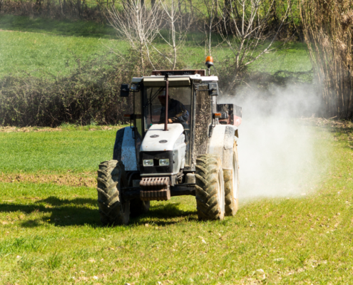 Photo of tractor spreading lime in a field