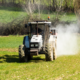 Photo of tractor spreading lime in a field