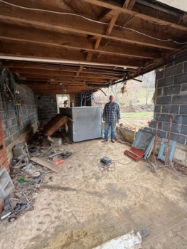 Photo of Gene in his barn damaged by Hurricane Helene.