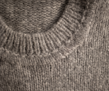 Close-up photo of medium-gray wool sweater.