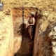 Dr. Faye Smith Measuring Soil Health in a soil pit.
