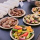 plates of prepared vegetables on a table