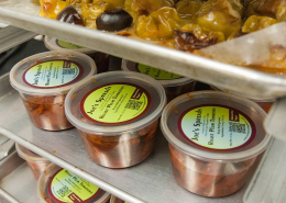 clear plastic containers of food sit on shelves
