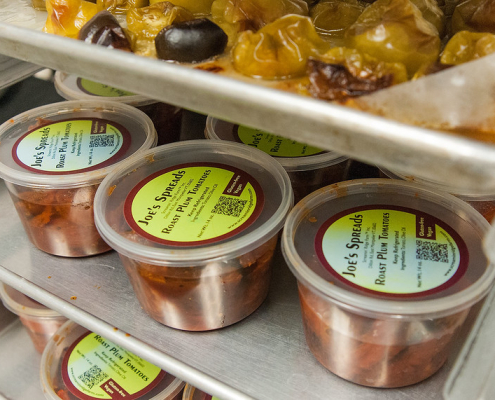 clear plastic containers of food sit on shelves