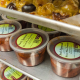 clear plastic containers of food sit on shelves