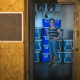 looking through a doorway at a person standing in front of coolers in a produce cooling room