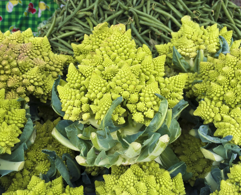 Romanesco broccoli with green beans in background