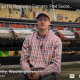 A seated person in front of farm equipment