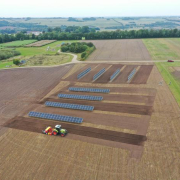 aerial view of solar panels on a plowed farm field