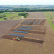 aerial view of solar panels on a plowed farm field