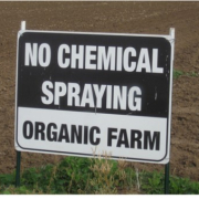 A sign that says "no chemical spraying - organic farm"