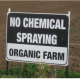 A sign that says "no chemical spraying - organic farm"