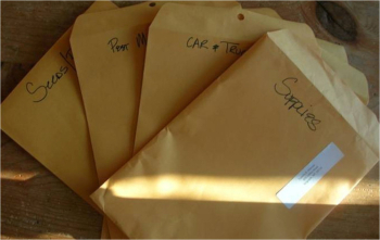 Manilla folders fanned out to show different farm receipt categories written on them. 