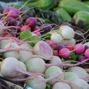 stacks of vegetables on display at market
