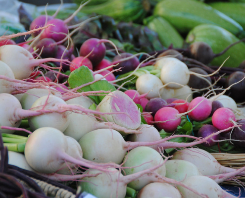 stacks of vegetables on display at market
